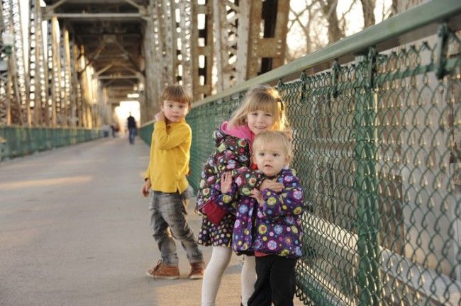 Three young walkers try out the Meridian Bridge on its reopening day as a footbridge.